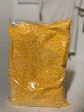 Bag of yellow corn kernels on a neutral background